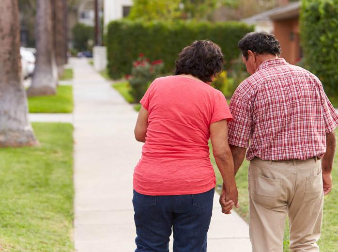 couple walking down sidewalk