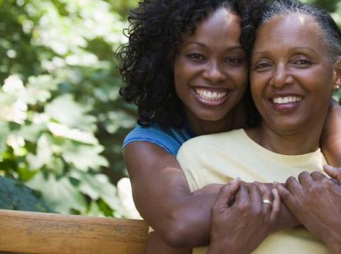 Two women smiling and embracing